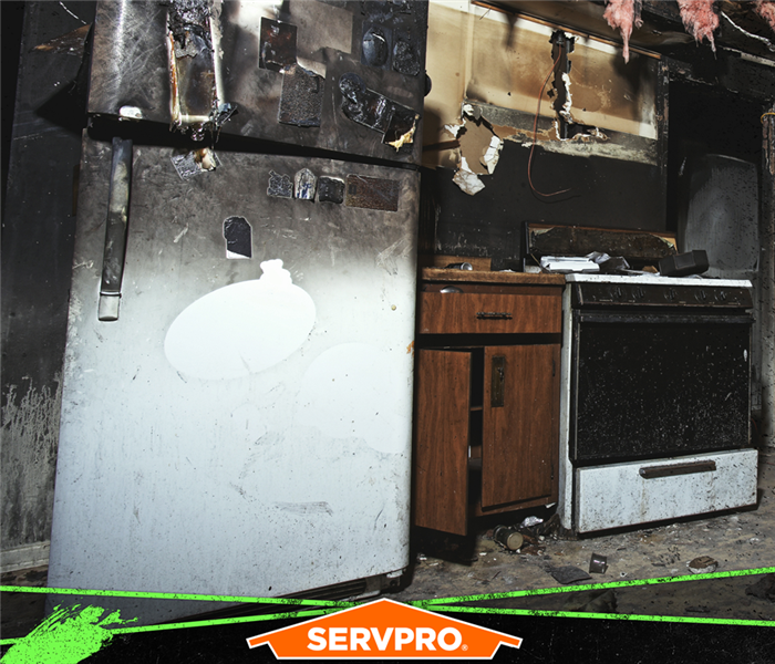 Fire and soot damage in a kitchen.