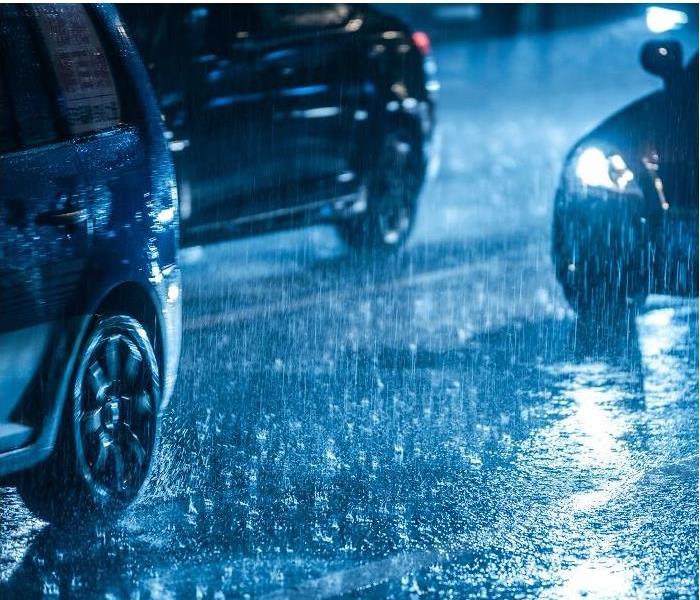 cars on busy street during storm
