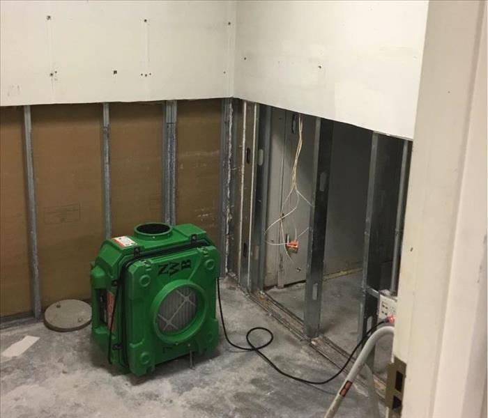 demolition of drywall, air mover nearby
